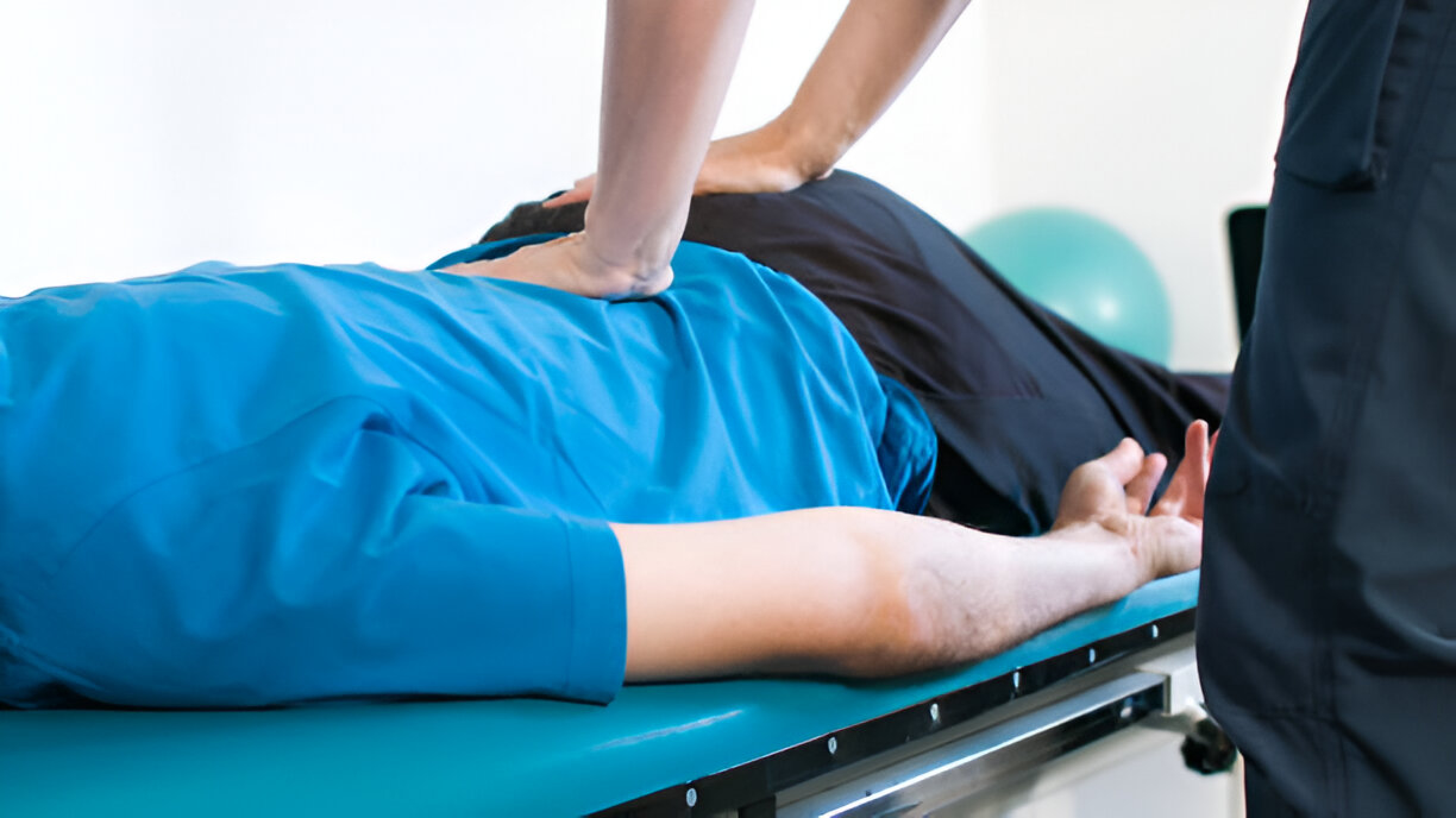 Here, a person is skillfully giving another person a spinal massage.