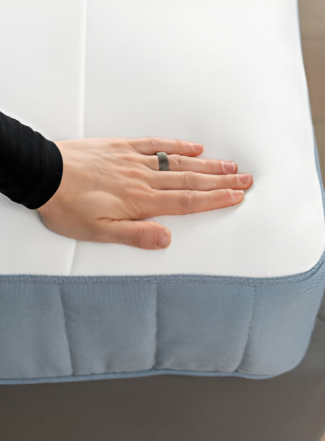 Here, a girl is comparing latex vs memory foam mattresses with her hands on a white mattress.